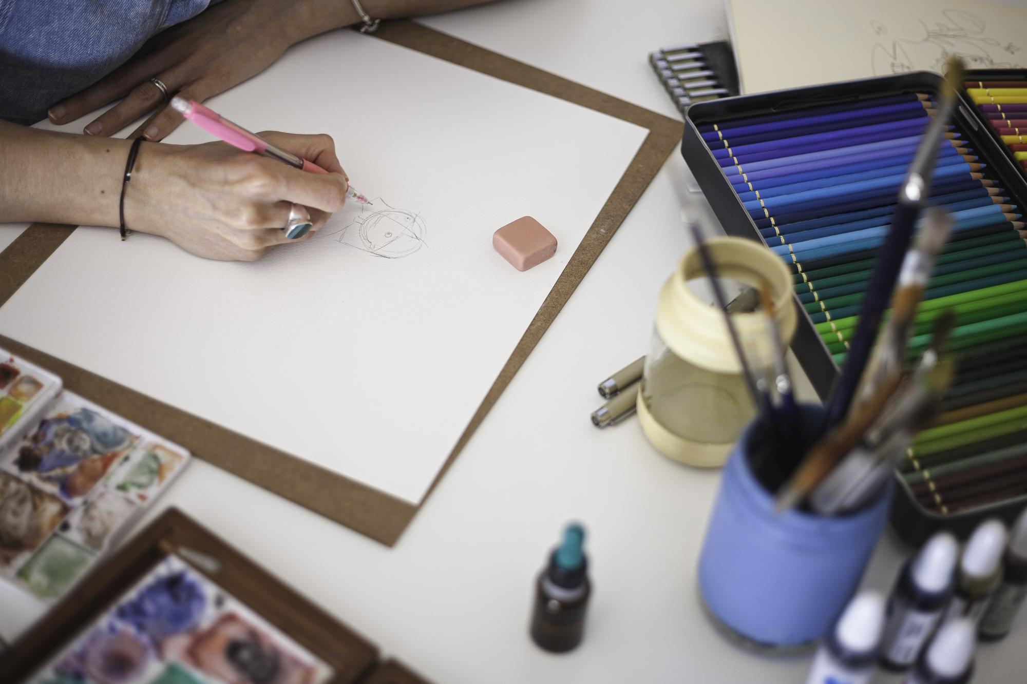 Designer sketch and thread samples on table